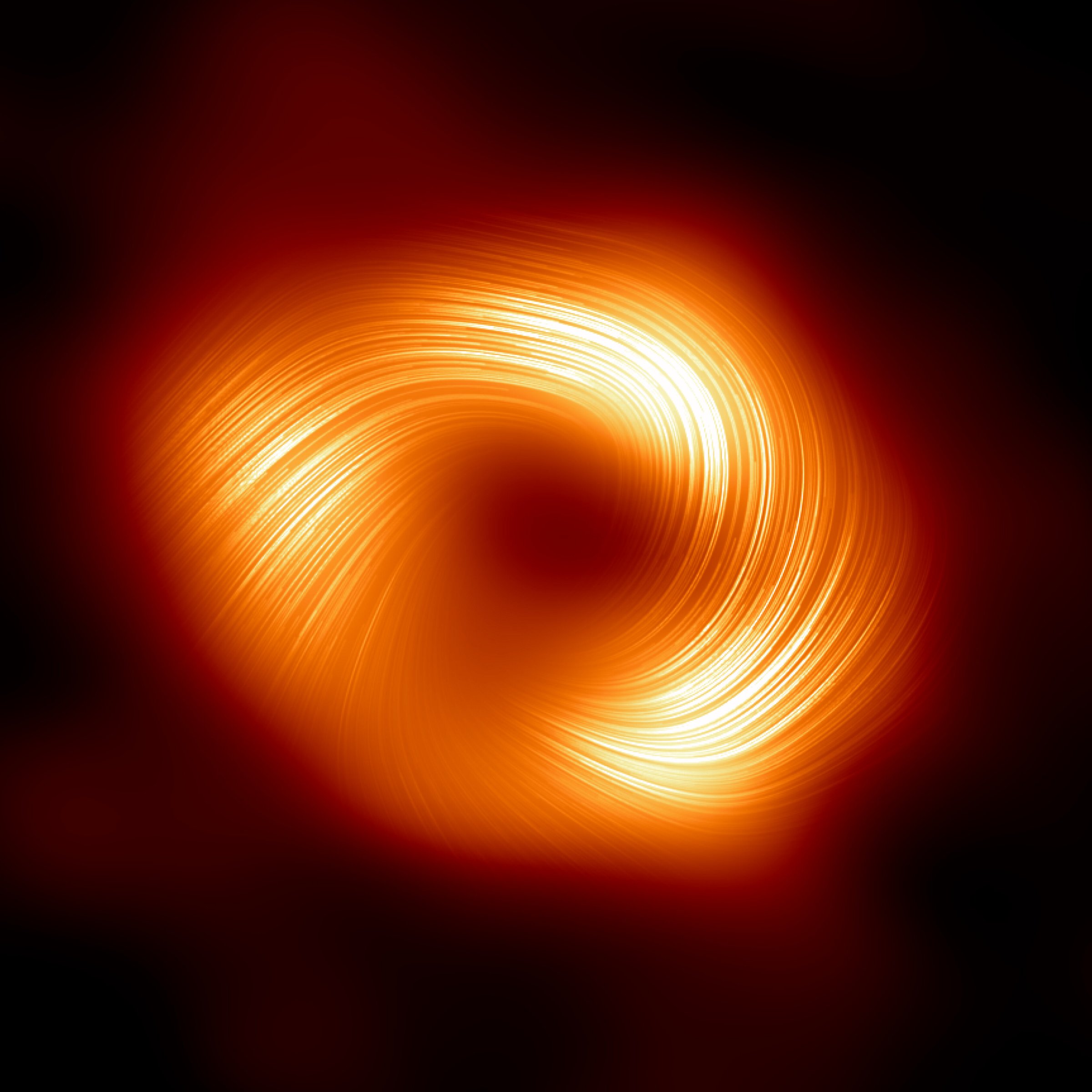 Das Schwarze Loch SgrA*: Die Magnetfelder liegen spiralförmig um den zentralen Schatten des Schwarzen Lochs herum. Bild: EHT Collaboration